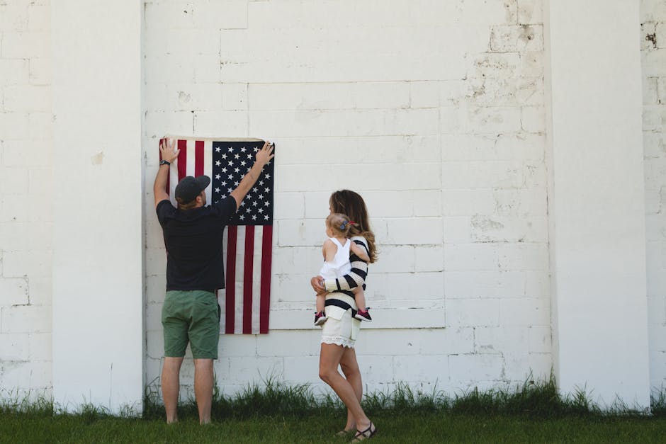 Family placing a flag on a white wall
